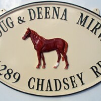 cast metal sign with horse