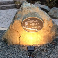 Metal sign mounted on rock