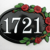 Cast metal sign with rose border